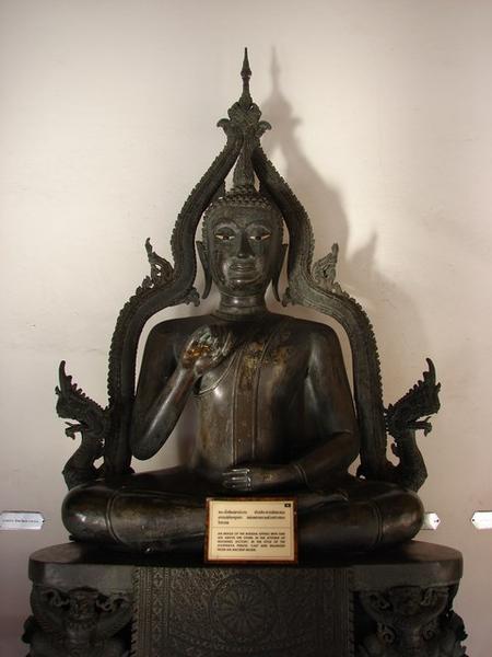 An image of the Buddha sitting with one leg above the other in the attitude of invoking victory