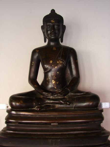 An image of the Buddha sitting cross-legged in the attitude of meditation