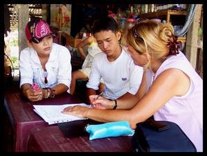 Thanh translating, Hoi and Karen. (L to R)