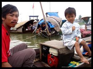Thanh and his father at home on their boat.