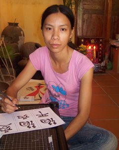 Ly learning the symbols painted on her good fortune journals
