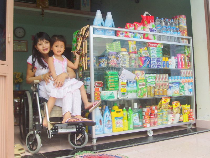 HOA & THINH AT THEIR STORE AT THE FRONT OF THEIR HOUSE