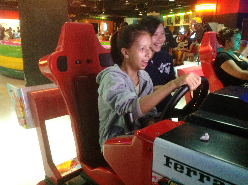 Students play a racing game at the Arcade