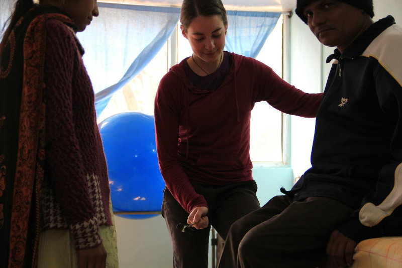   Teaching reflex testing with the rehabilitation worker at the Shakyamuni Buddha Community Health Care Centre, Bodhgaya, India