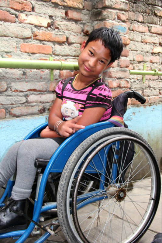 One of the orphaned children of the Special Education Rehabilitation Center (SERC) school eagerly waiting her treatment, Kathmandu, Nepal