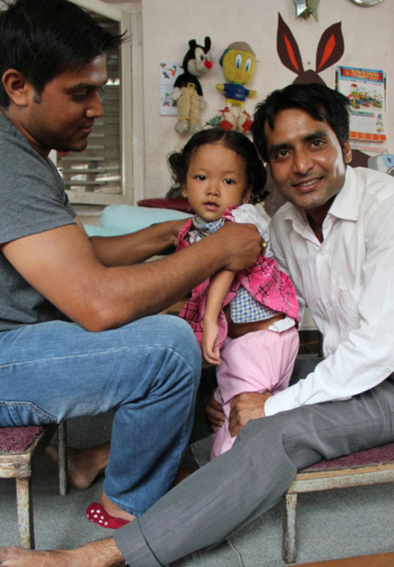Special Education Rehabilitation Centre staff working with one of their younger members, Kathmandu, Nepal