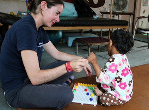 Playing games to improve coordination and fine motor control with children at the Special Education Rehabilitation Centre (SERC) school. Kathmandu, Nepal.