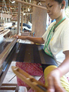 A lady working a loom
