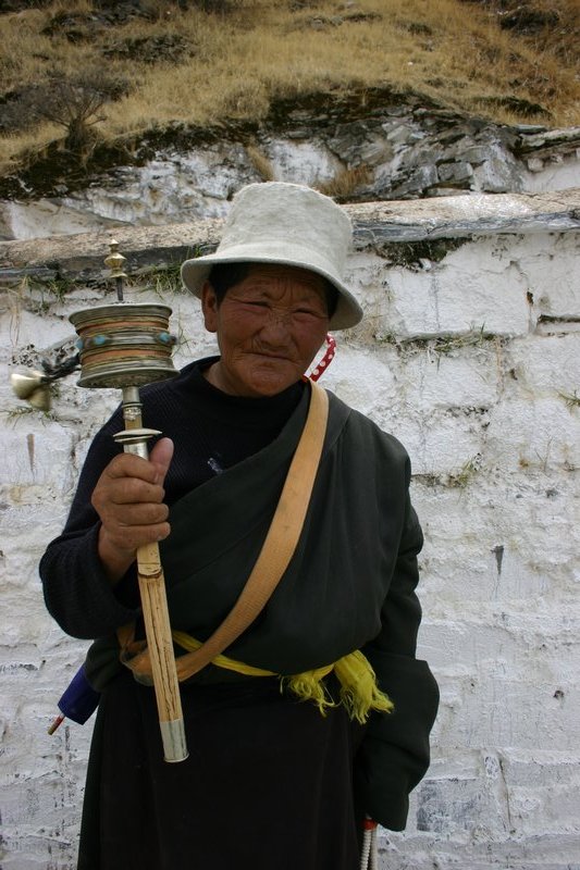 Old lady with prayer wheel