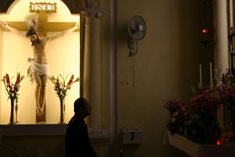 Man in prayer at Macau cathedral