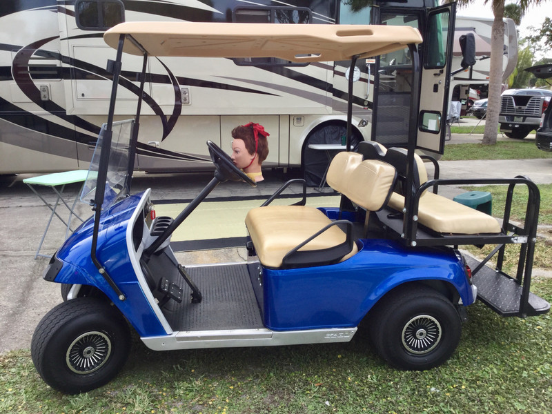 Lulu steers the golf cart