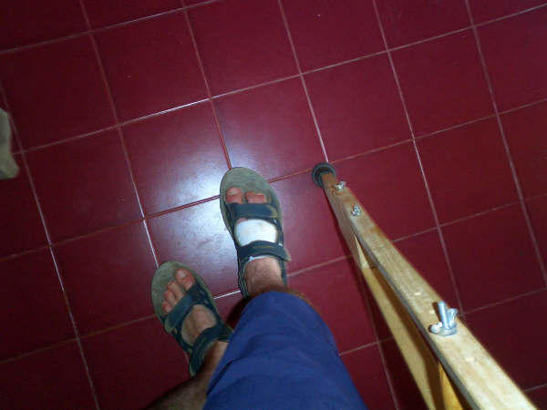 One foot bandaged and one crutch left......