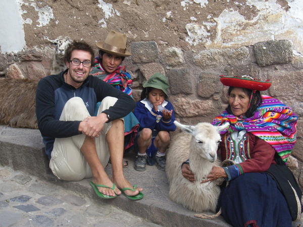 One gringo, three locals and two llamas on a street corner in Cusco.