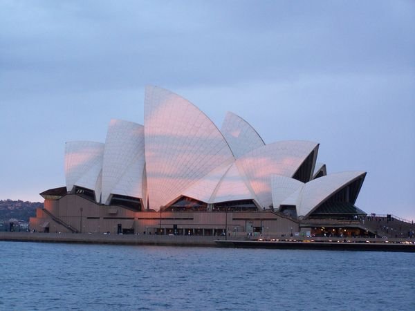 Sun set on Sydney Opera House with reflections Sydney Harbour Bridge. 