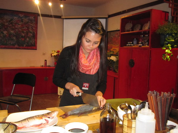 Me cutting the river bass during our Cantonese cooking class!
