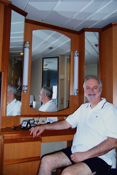 John sits at our desk in our stateroom