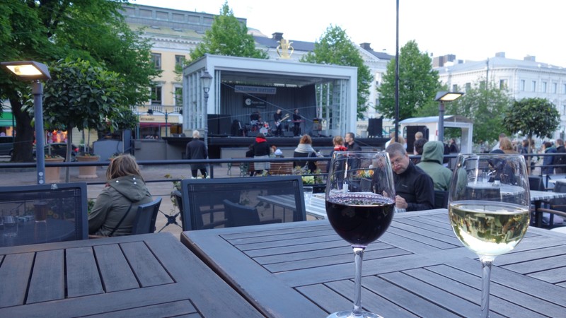 Enjoying a local band with a glass of wine