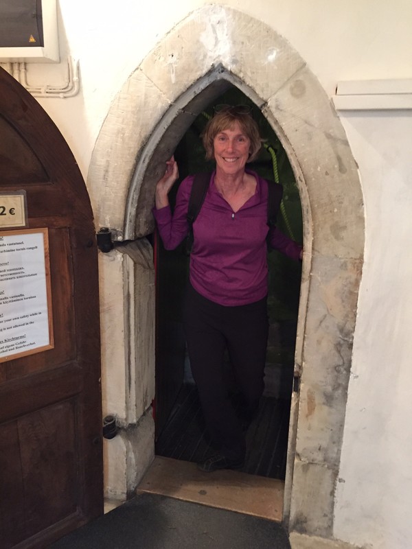 Pam about to go up stairway in tower at St Olaf's Cathederal