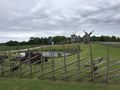 Typical Estoniain farm fence in fore ground; windmills in background