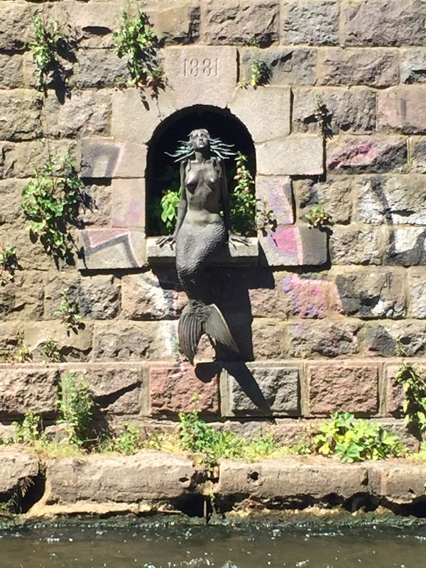 Statue of mermaid along river in Uzupis