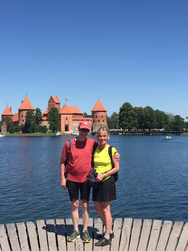2 intrepid explorers with castle in background at Trakai