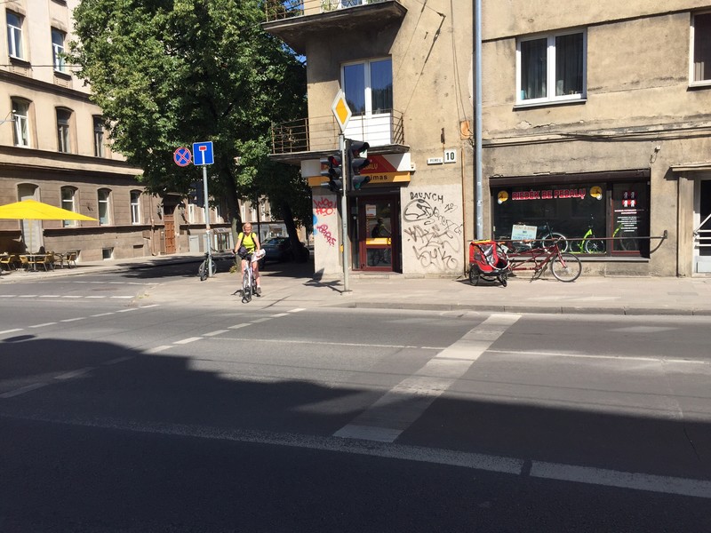 Pam in front of bike shop in Vilnius