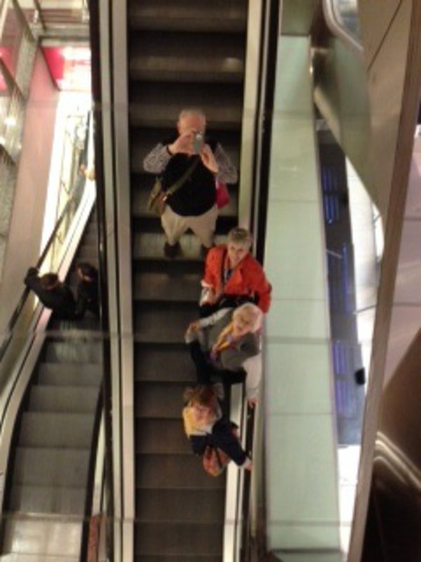 Tourists on escalator.   :  )