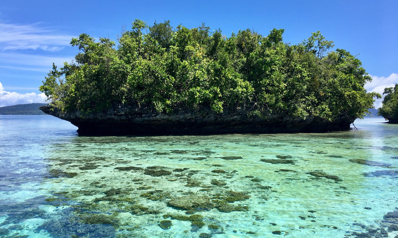 Små klatter af øer, i det mest lyseblå vand. Det er koraller man kan ane i vandet.