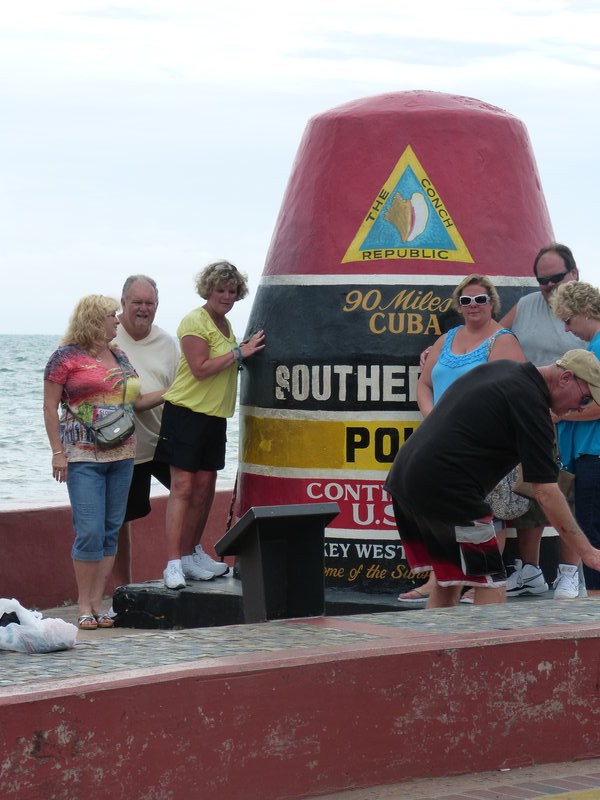 A rather large random family obstructing everyones view of the southernmost point of Key West!