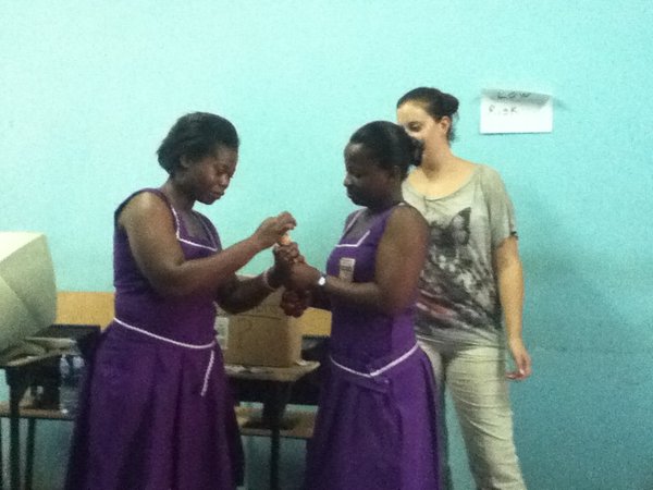 Students doing a condom demonstration during HIV/AIDS workshop