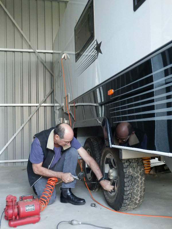 Greg checks the tyre pressure to make sure that the caravan is ready.