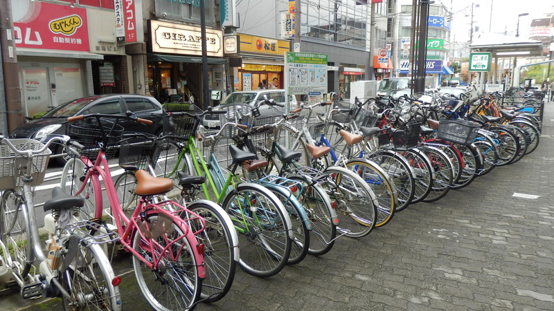 A bicycle park. Bikes are locked in place and a fee is paid to unlock them.