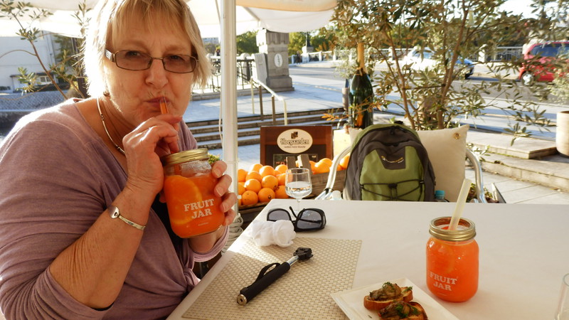 Joan sucking on a Campari and orange juice cocktail, accompanied with oysters on bruschetta. 