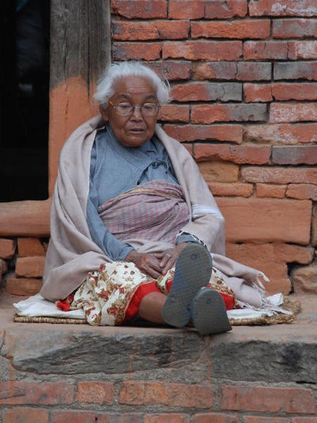 Lady watching pots dry in the Potters Square, Bhaktapur