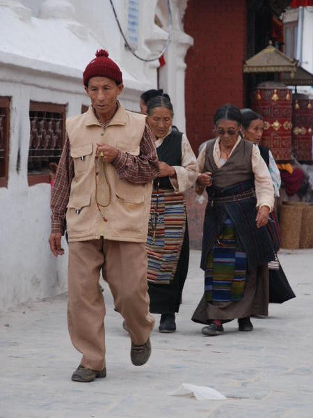Tibetans circumnavigating the stupa, Bodhnath
