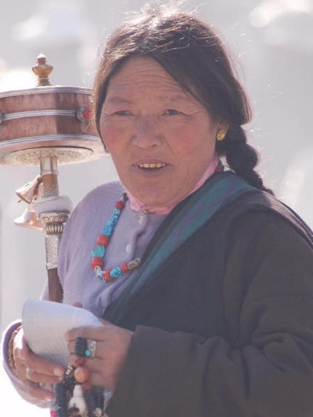PIlgrim loaded up with Prayer wheel and beads