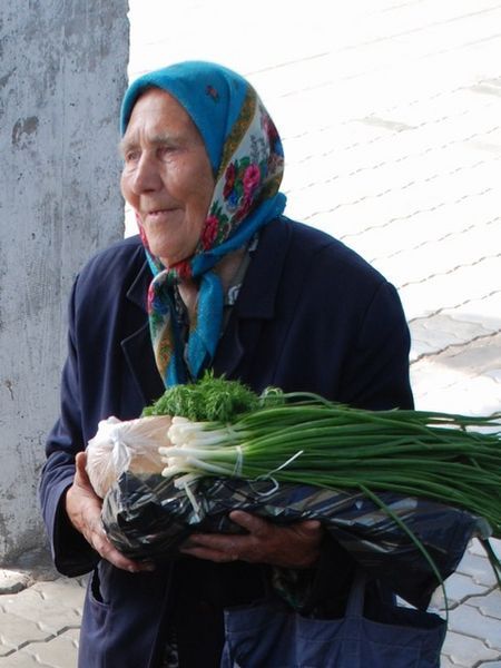 Babushka selling veges on the platform