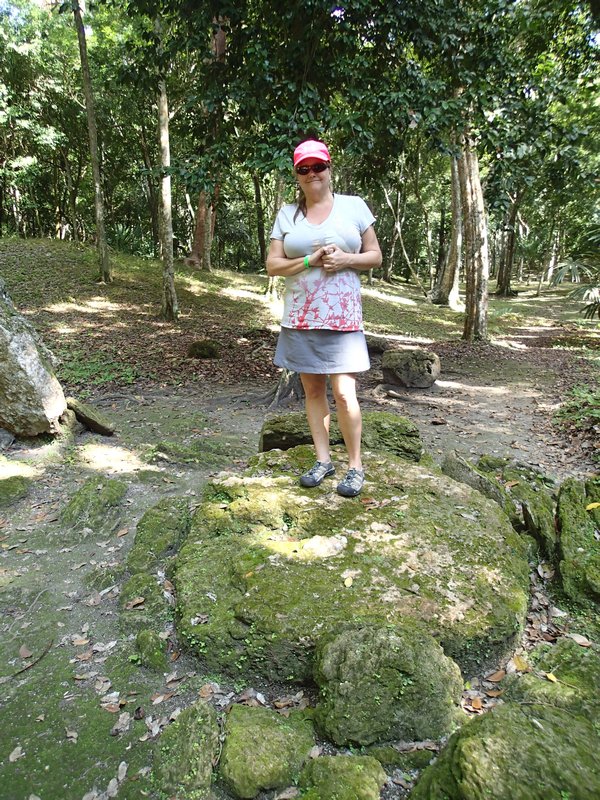Ann on sacrificial stone at Yaxha...
