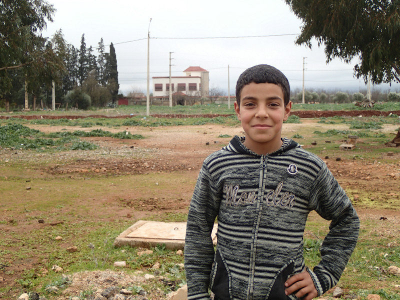 Abraha with his house in the background.