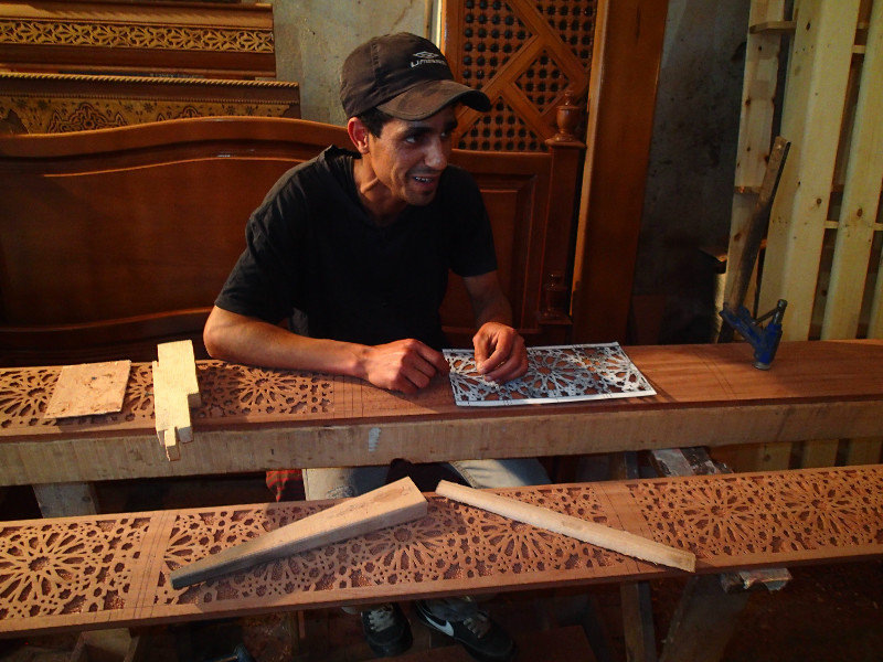 One of the workers cutting out the design in our wood by hand!