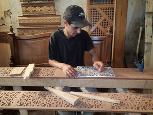 One of the workers cutting out the design in our wood by hand!