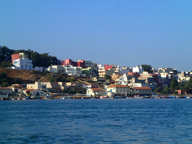 The fishing boats and charming hill above.