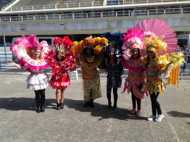 Tourists try on costumes from Carnival