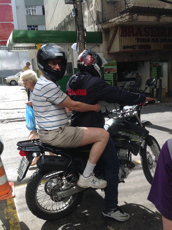 Wayne gets a lift on a motorcycle taxi