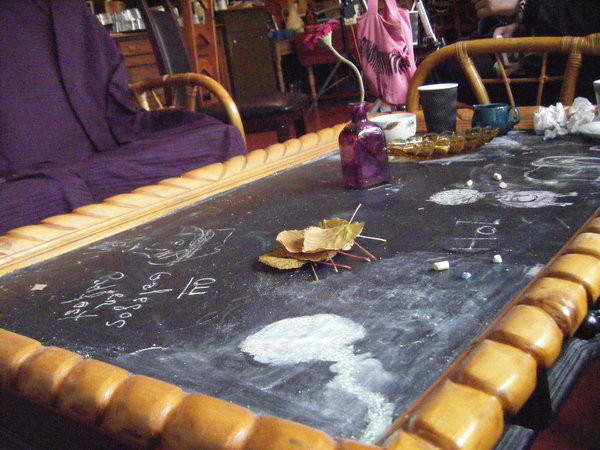 Chalkboard table displaying our genius artwork