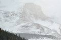 Light snow veils mountain top