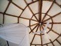 Circular chalet ceiling, with mosquito net over the bed