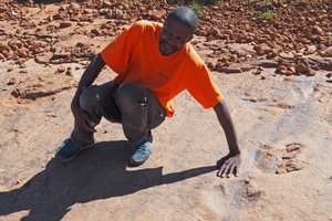 Tseiso Koeshe showing dinosaur footprints