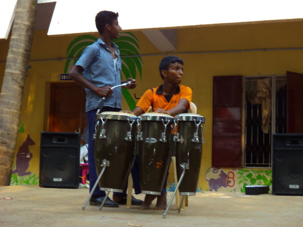 Performing drums and singing