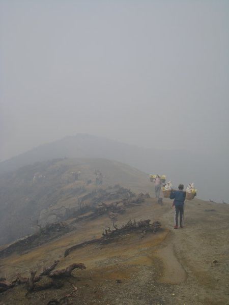 Workers trekking along the crater rim